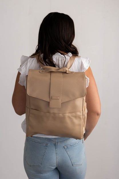 Photo of woman wearing Hallie Classic Breast Pump Bag as a backpack (shown with a front view of backpack)